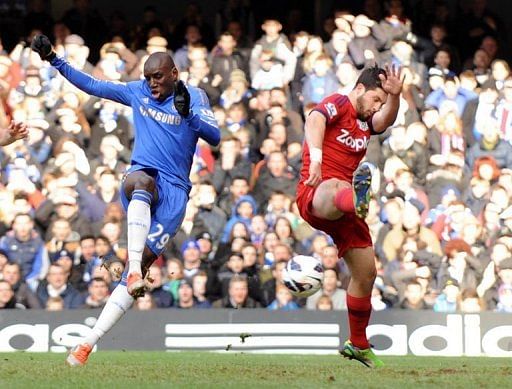 Chelsea's striker Demba Ba (L) shoots to score past West Bromwich Albion's striker Shane Long, March 2, 2013
